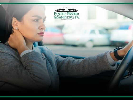 Woman driving a car with focused expression, traffic visible through windshield