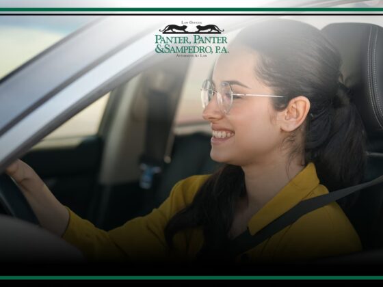 Teen driver smiling while driving car